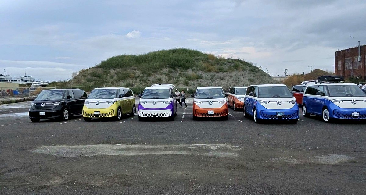 Six Volkswagen ID. Buzz vans parked nose-on in a row in a Bellingham parking lot.